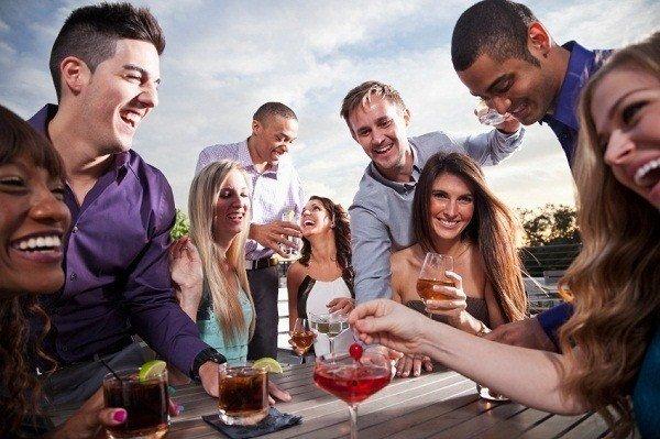 Group of young adults drinking outdoors