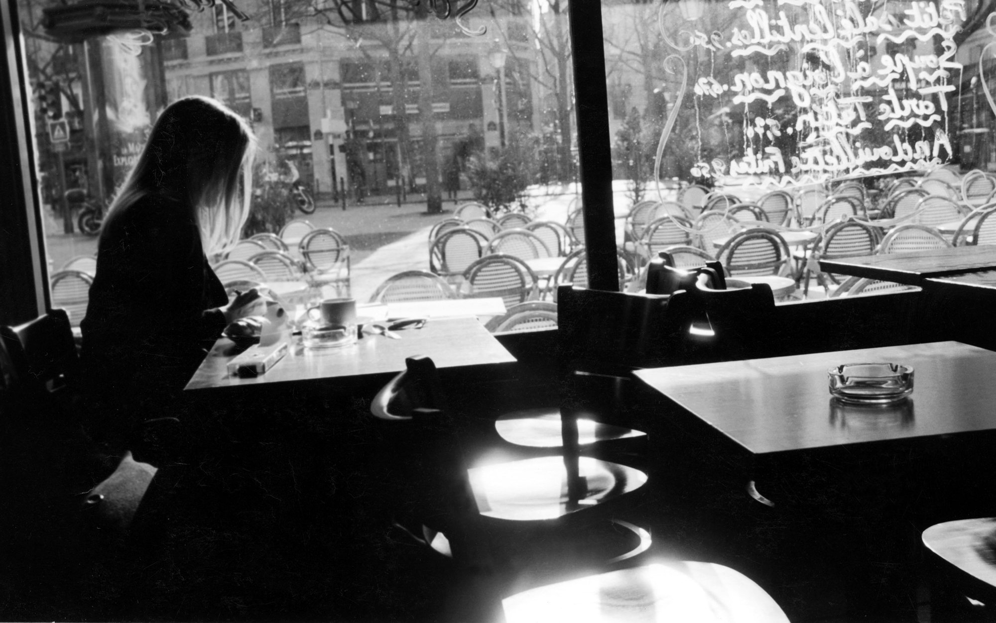 header_ESSAY-Girl-in-cafe-in-Paris-120383778_master