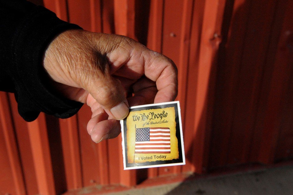 A person displays a card received after voting at a polling station on the Standing Rock Indian Reservation in Cannon Ball, North Dakota