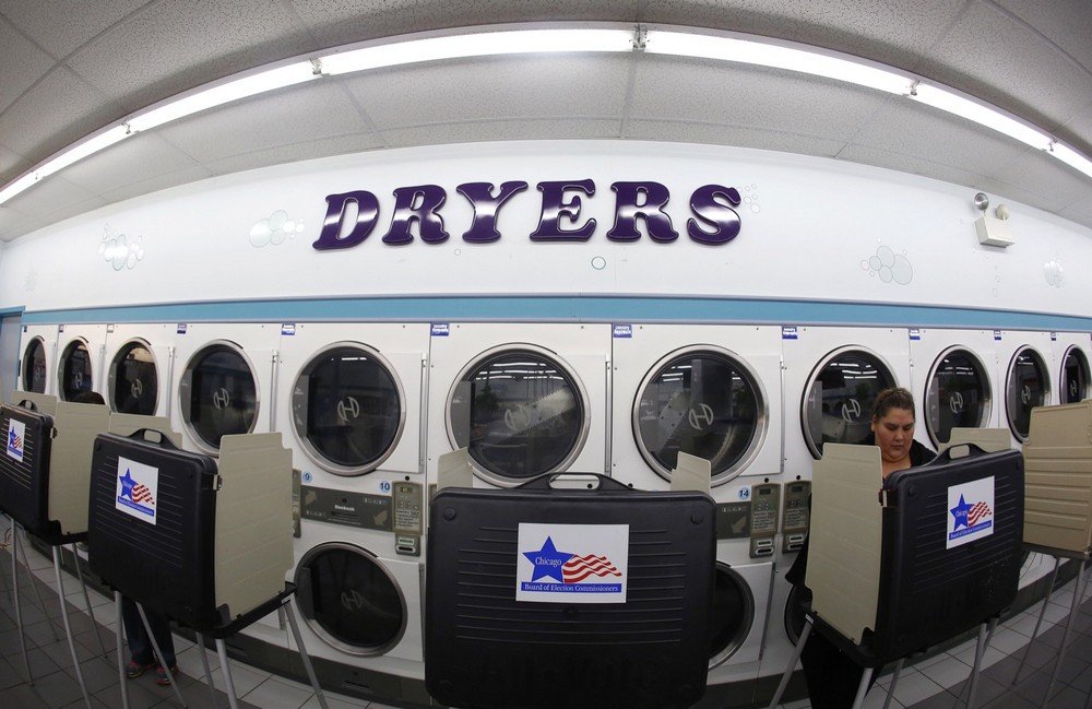 A voter steps up to casts her ballot in the U.S. presidential election at Su Nueva Lavanderia in Chicago